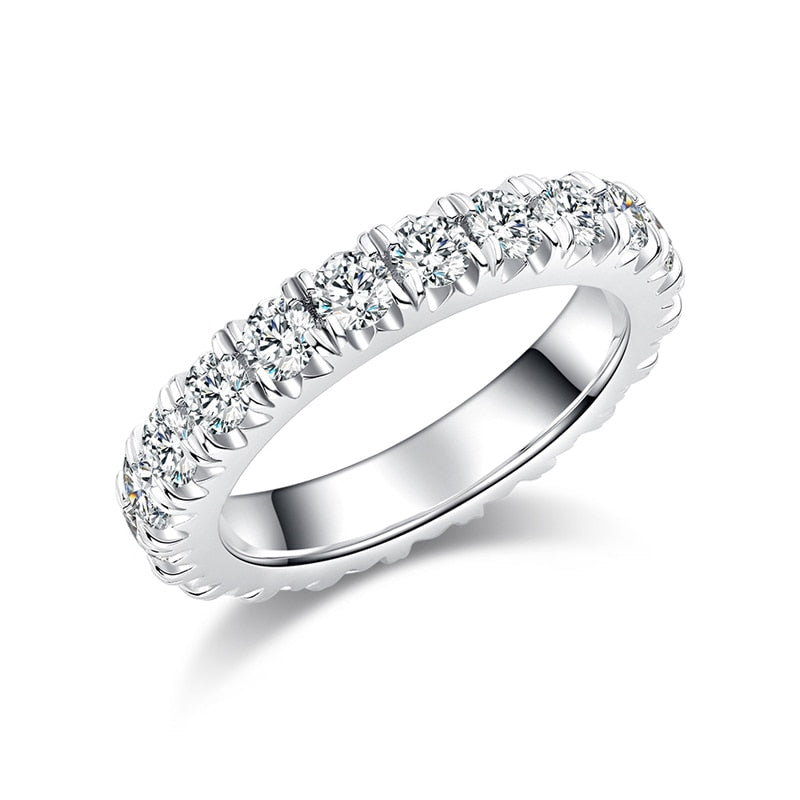 A silver moissanite infinity ring that has deep side set scallops.