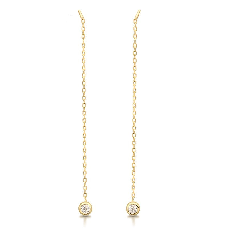 A gold pair of chain dangle earrings bezel set with moissanite.