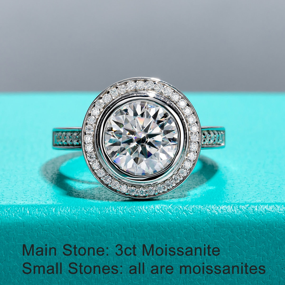 A vintage style ring with 3CT moissanite bezel set surrounded with a halo and pave band.