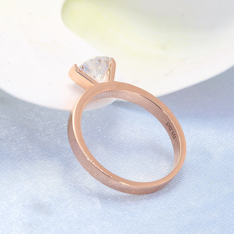 A gold tension set floating moissanite ring.