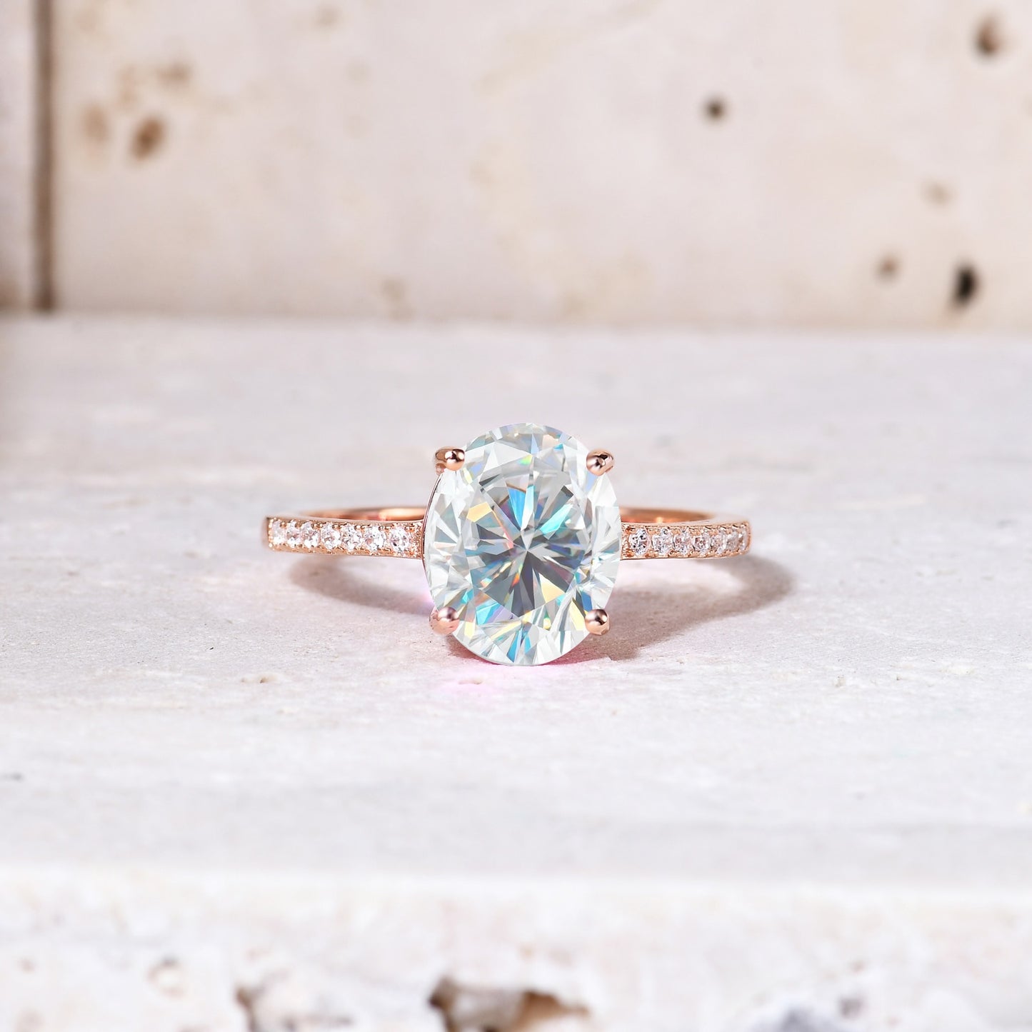 A rose gold pave band with moon and star cut outs on each side, set with a 3CT oval moissanite.