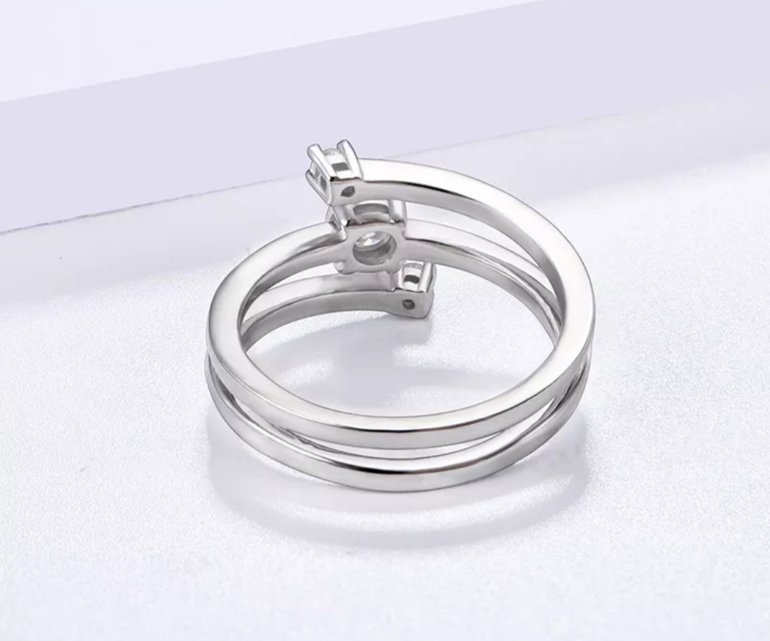 A silver spiral bypass 3 stone ring.