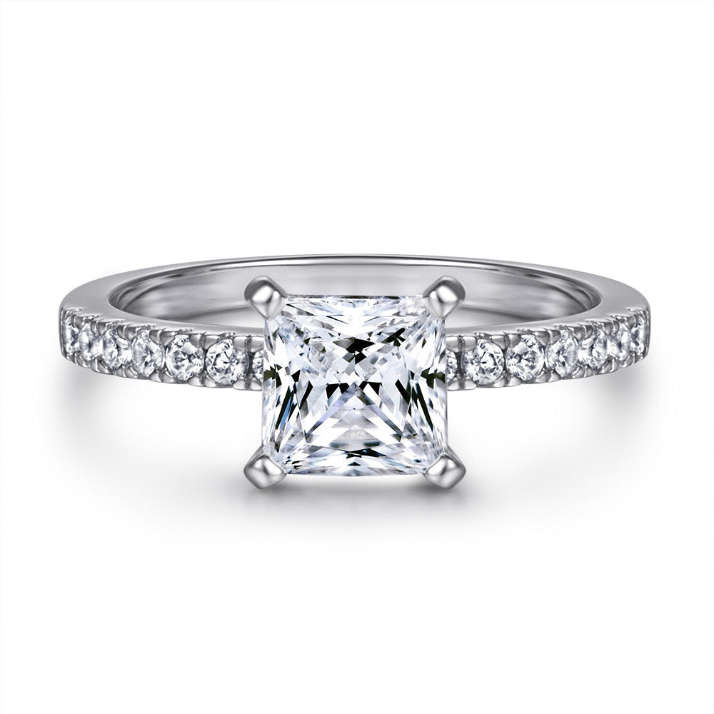 A silver princess cut engagement ring on a pave band.