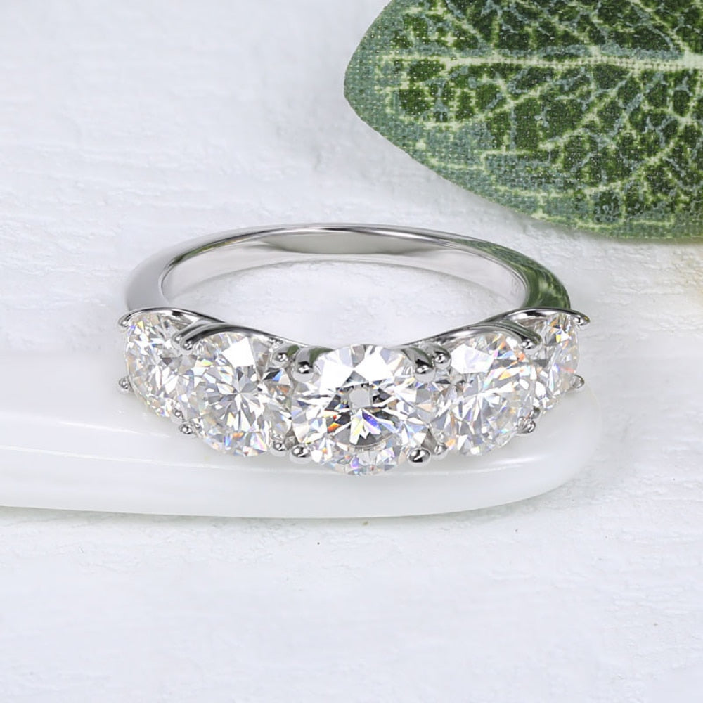 A silver 5 stone wedding ring.