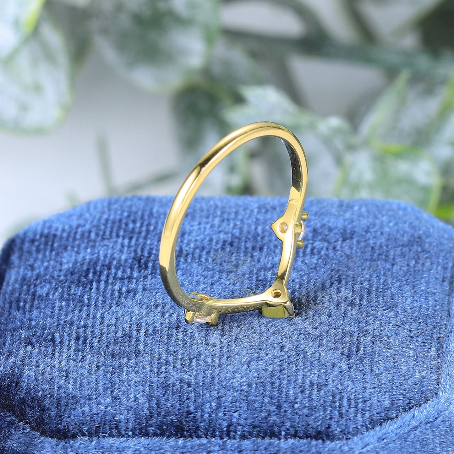A gold 3 stone chevron style wedding ring.