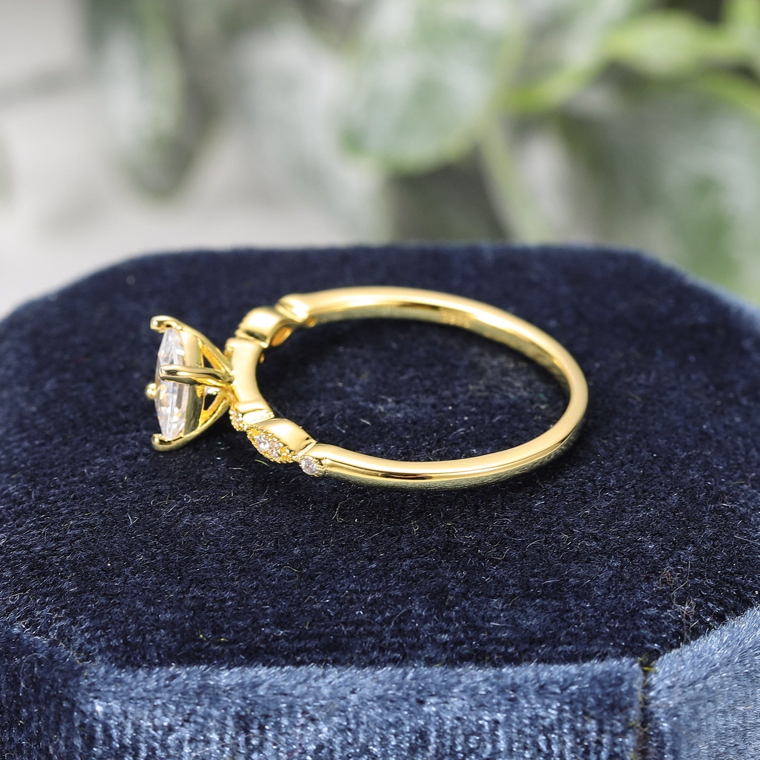 A gold art deco princess cut moissanite engagement ring.