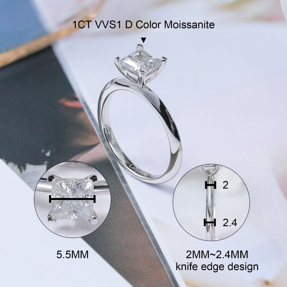 A silver engagement solitaire ring set with a princess cut moissanite with size of gem and shank.